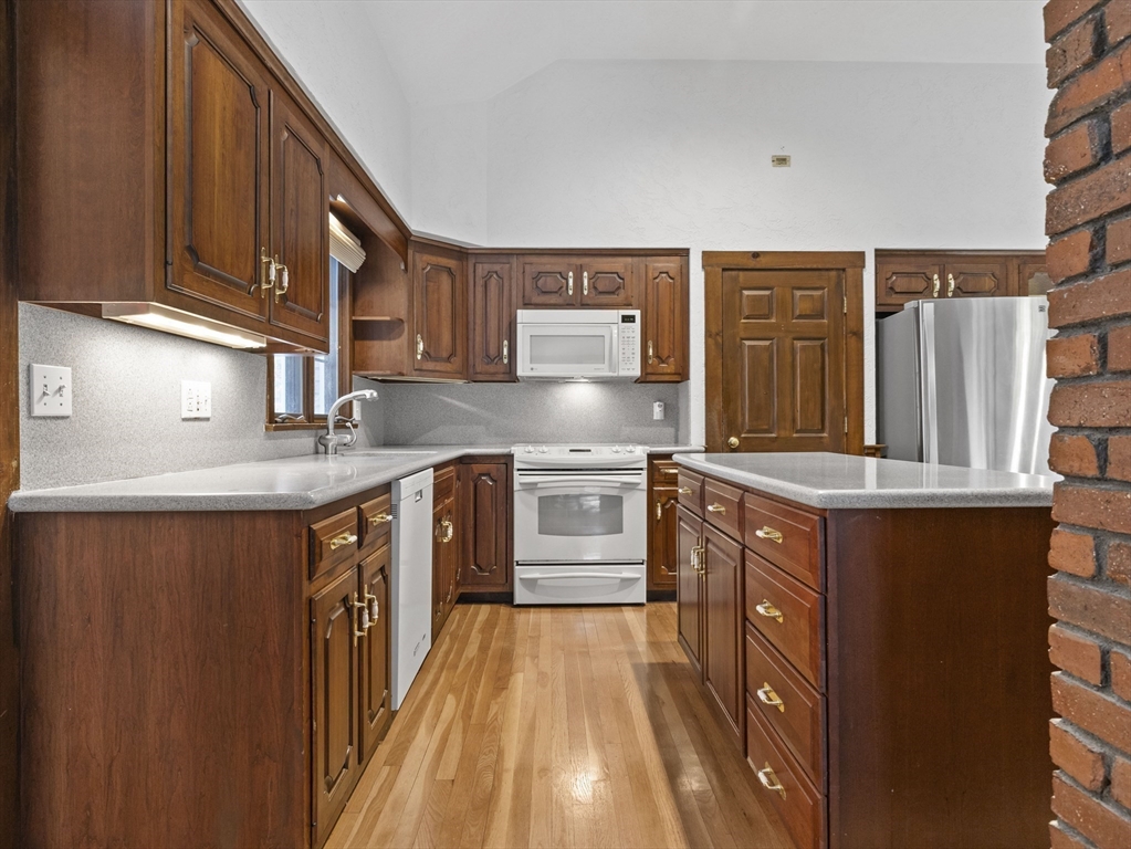 40 Audubon Road Wellesley, MA 02481 - Photo 7 of 21 a kitchen with stainless steel appliances granite countertop a stove a sink dishwasher and a refrigerator