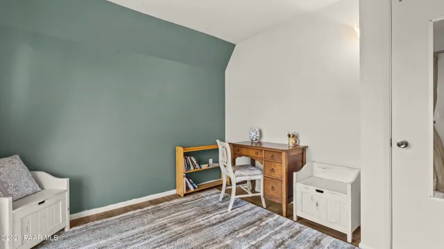 a living room with furniture a large window and a chandelier