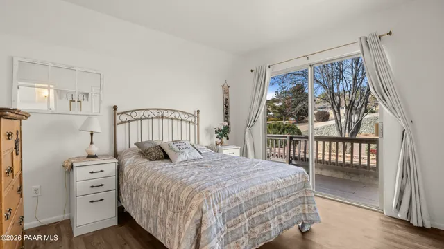 a kitchen with stainless steel appliances kitchen island granite countertop a table chairs microwave and sink