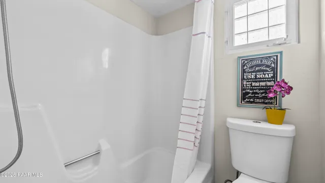 a dining room with furniture a rug and a floor to ceiling window