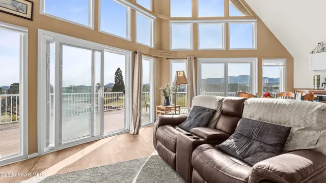 a living room with furniture and a floor to ceiling window