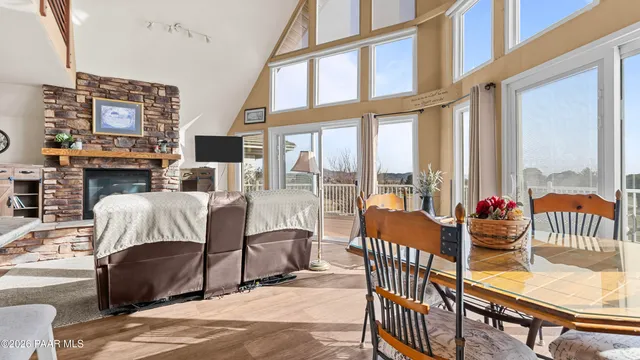 a living room with furniture a flat screen tv and a floor to ceiling window