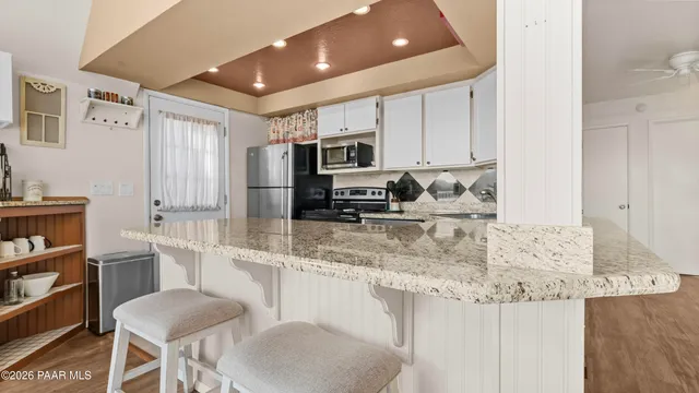 a bedroom with furniture and a flat screen tv