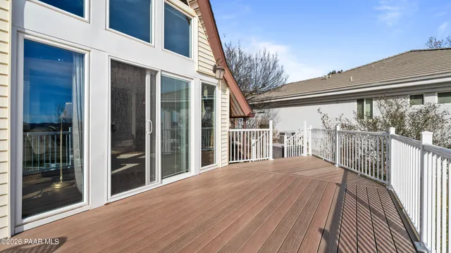 a view of a house with wooden fence