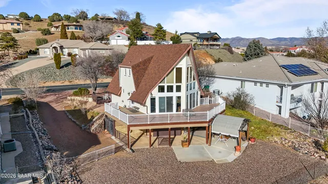 an empty room with a ceiling fan and window