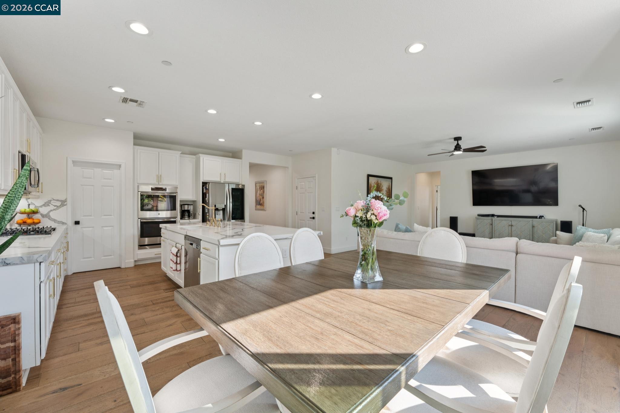 1226 Sierra Trail Road Oakley, CA 94561 - Photo 15 of 60 a living room with furniture a flat screen tv and a dining table