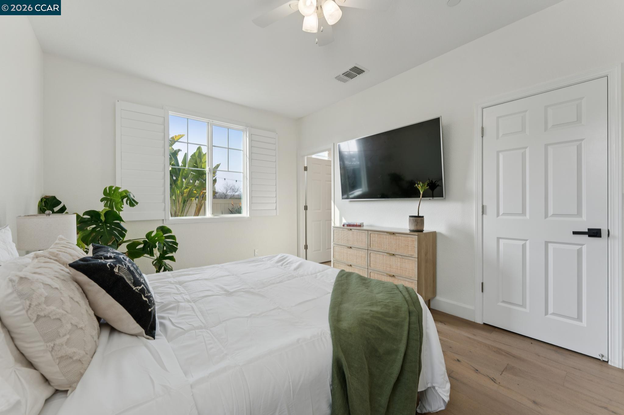 1226 Sierra Trail Road Oakley, CA 94561 - Photo 19 of 60 a bedroom with a bed window tv and potted plant