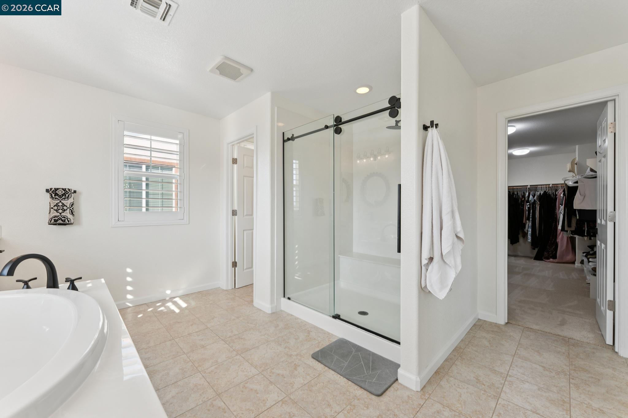 1226 Sierra Trail Road Oakley, CA 94561 - Photo 31 of 60 a bathroom with a tub shower and mirror