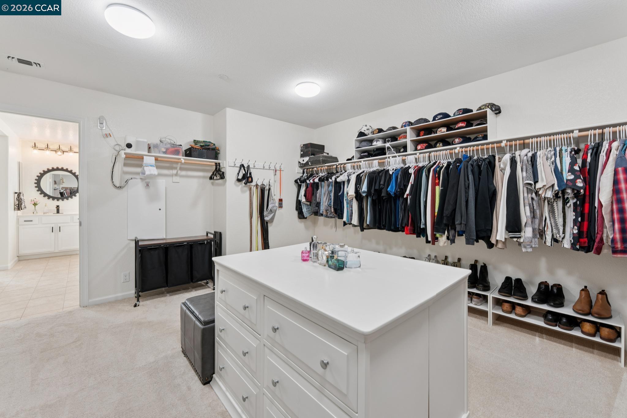 1226 Sierra Trail Road Oakley, CA 94561 - Photo 35 of 60 a view of walk in closet with clothes and shoes