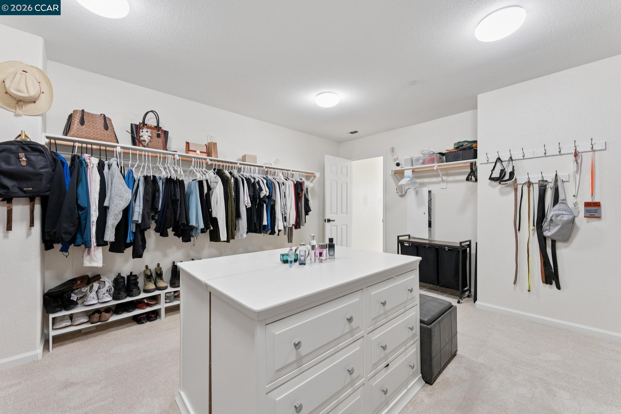1226 Sierra Trail Road Oakley, CA 94561 - Photo 36 of 60 a view of walk in closet with clothes and shoes