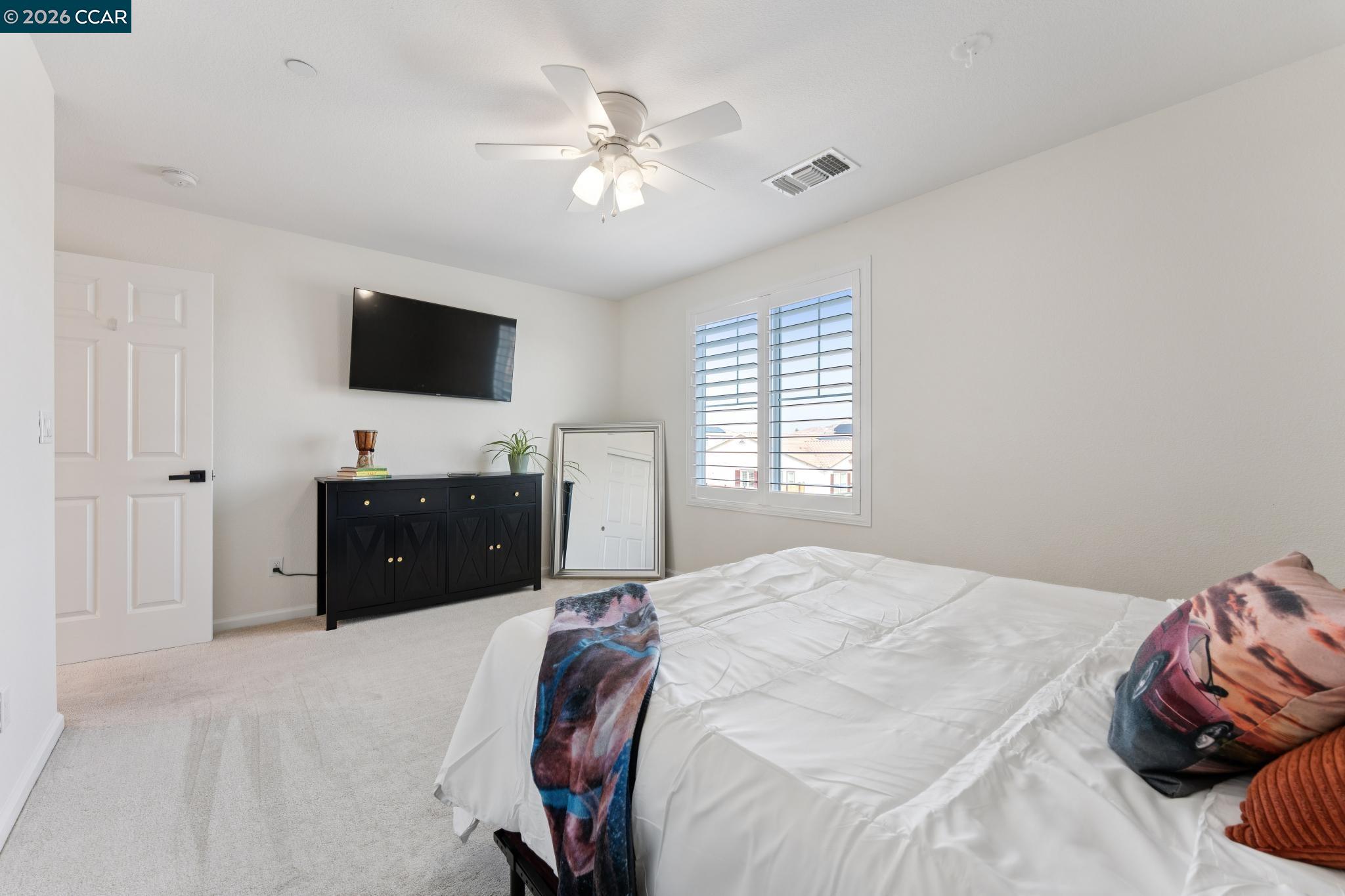 1226 Sierra Trail Road Oakley, CA 94561 - Photo 41 of 60 a spacious bedroom with a bed and a flat screen tv