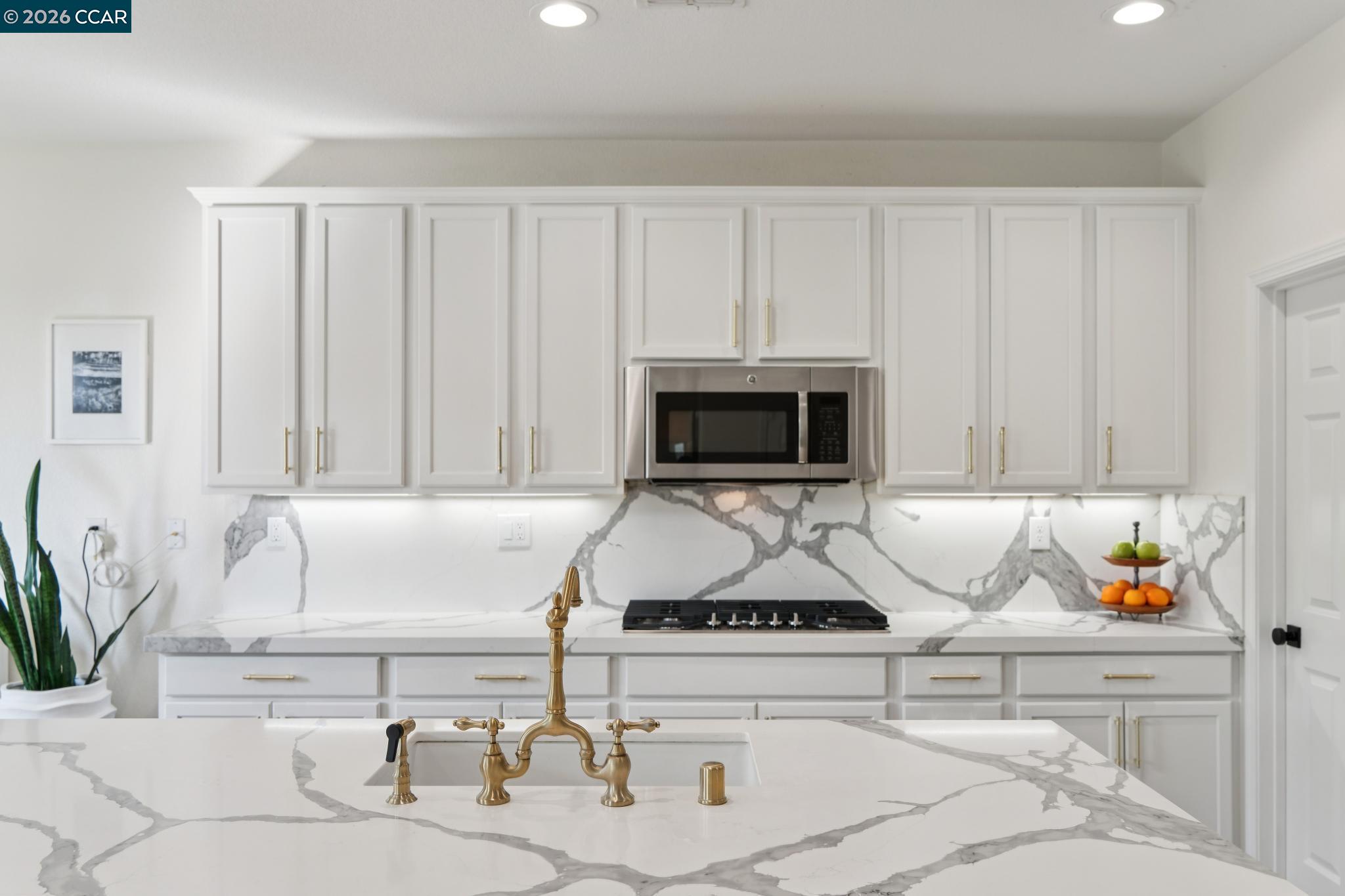 1226 Sierra Trail Road Oakley, CA 94561 - Photo 10 of 60 a kitchen with a sink and a stove top oven