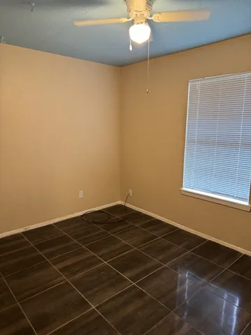 a view of an empty room with a chandeliers