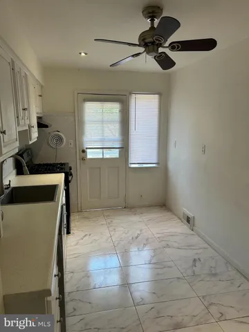 a view of a kitchen with a sink and cabinets