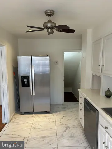 a view of a kitchen with a sink and a refrigerator
