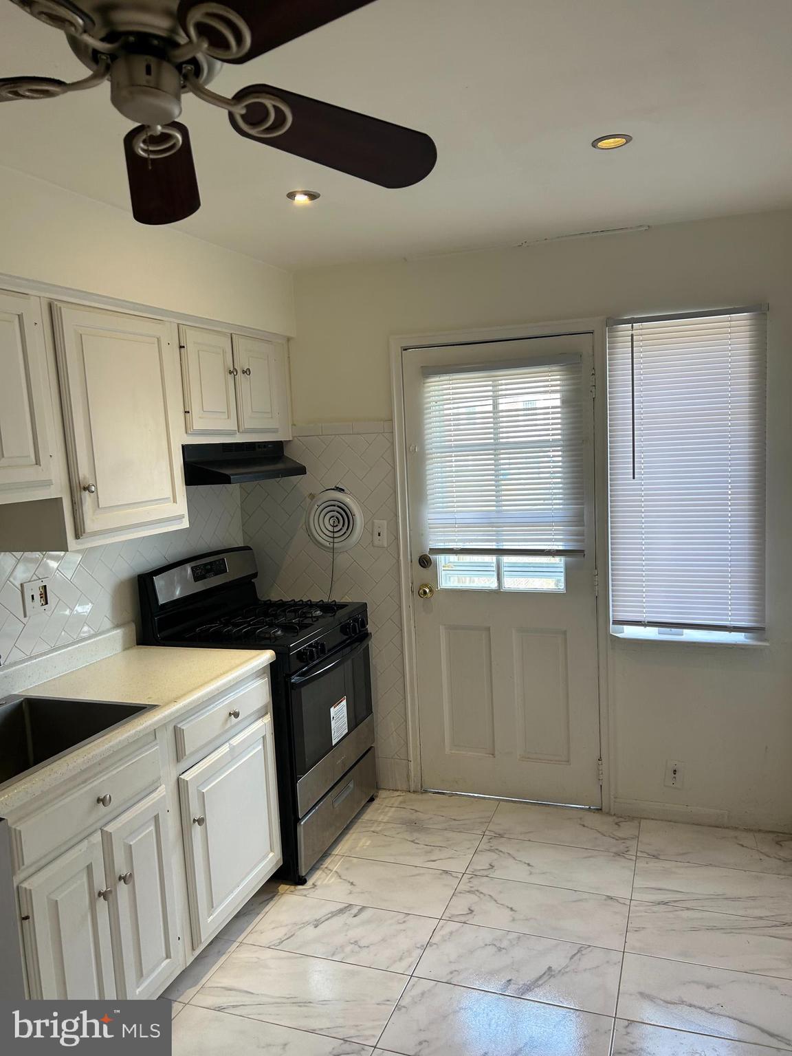 1804 Winford Road Baltimore, MD 21239 - Photo 8 of 18 a kitchen with a cabinets and appliances