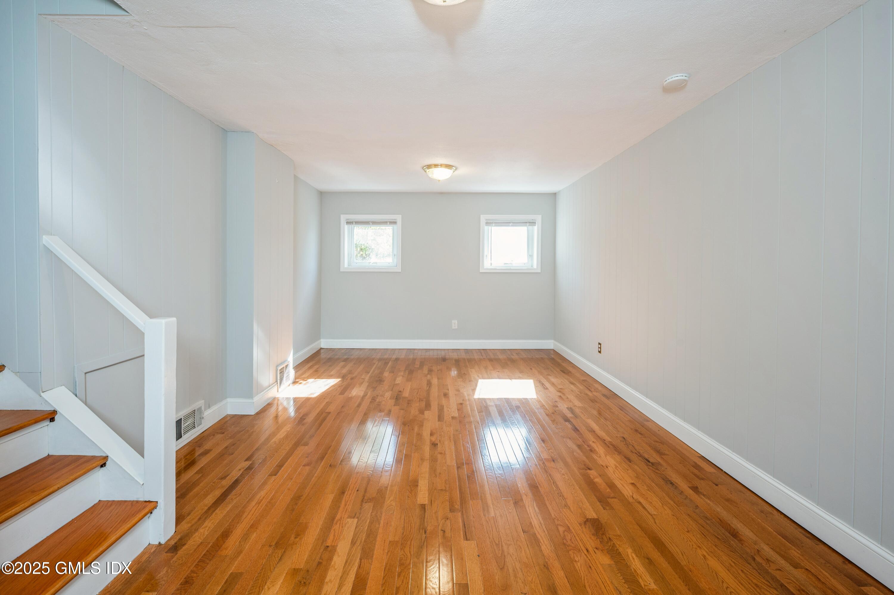 19 Bayside Terrace Riverside, CT 06878 - Photo 13 of 22 a view of empty room with wooden floor and fan