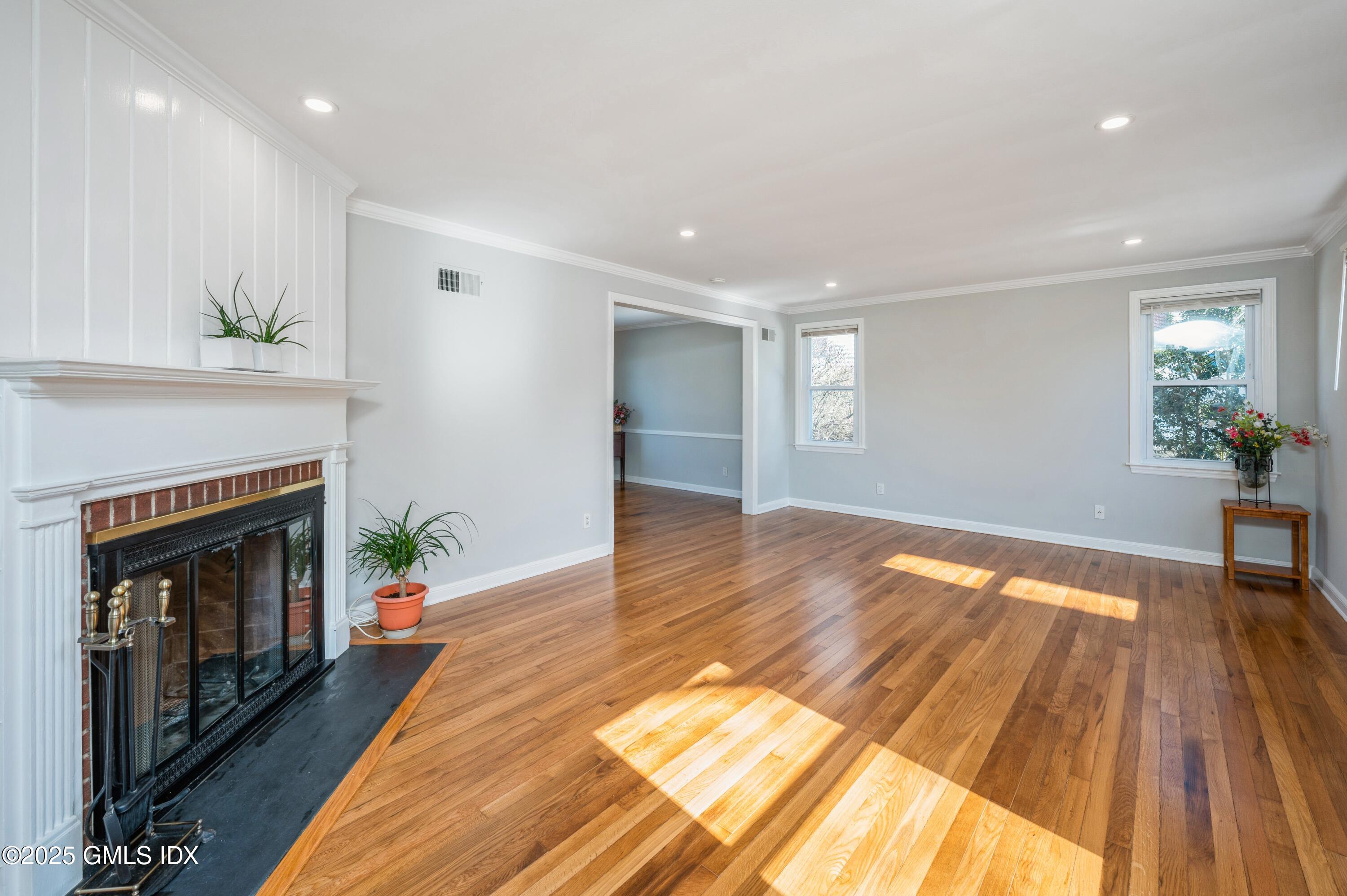 19 Bayside Terrace Riverside, CT 06878 - Photo 3 of 22 a view of an empty room with wooden floor and a fireplace