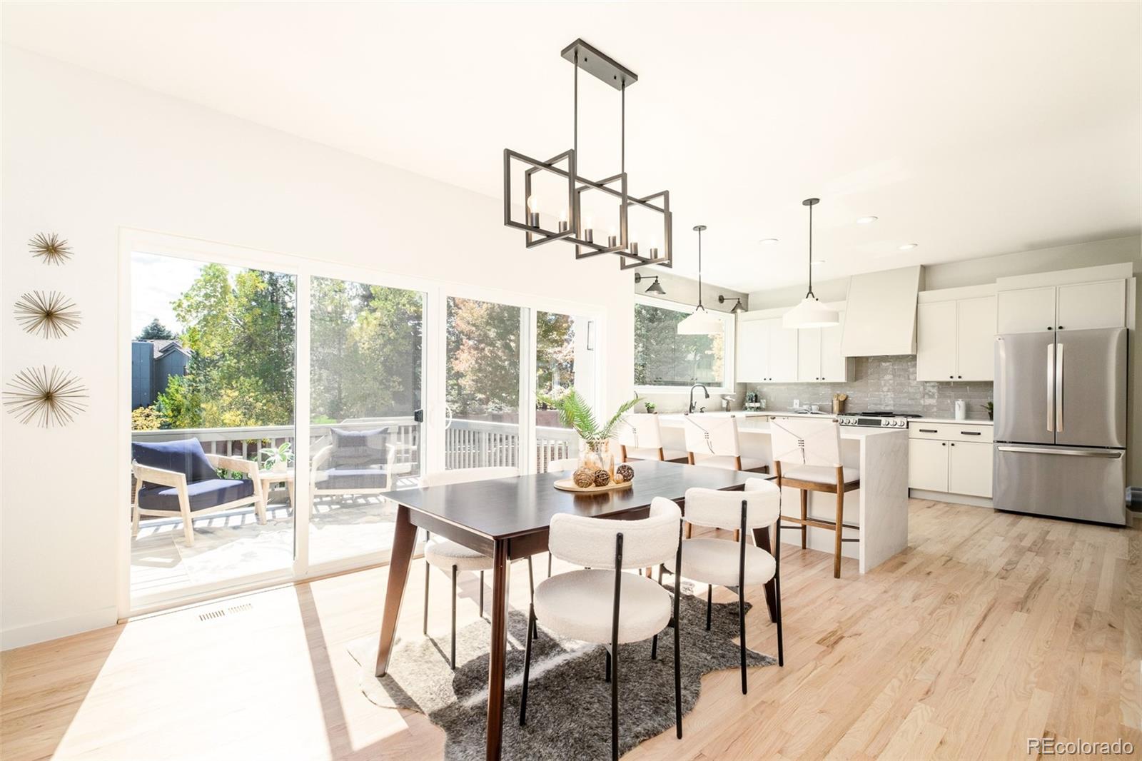 8176 Lone Oak Court Lone Tree, CO 80124 - Photo 11 of 50 a dining room with furniture a chandelier and wooden floor