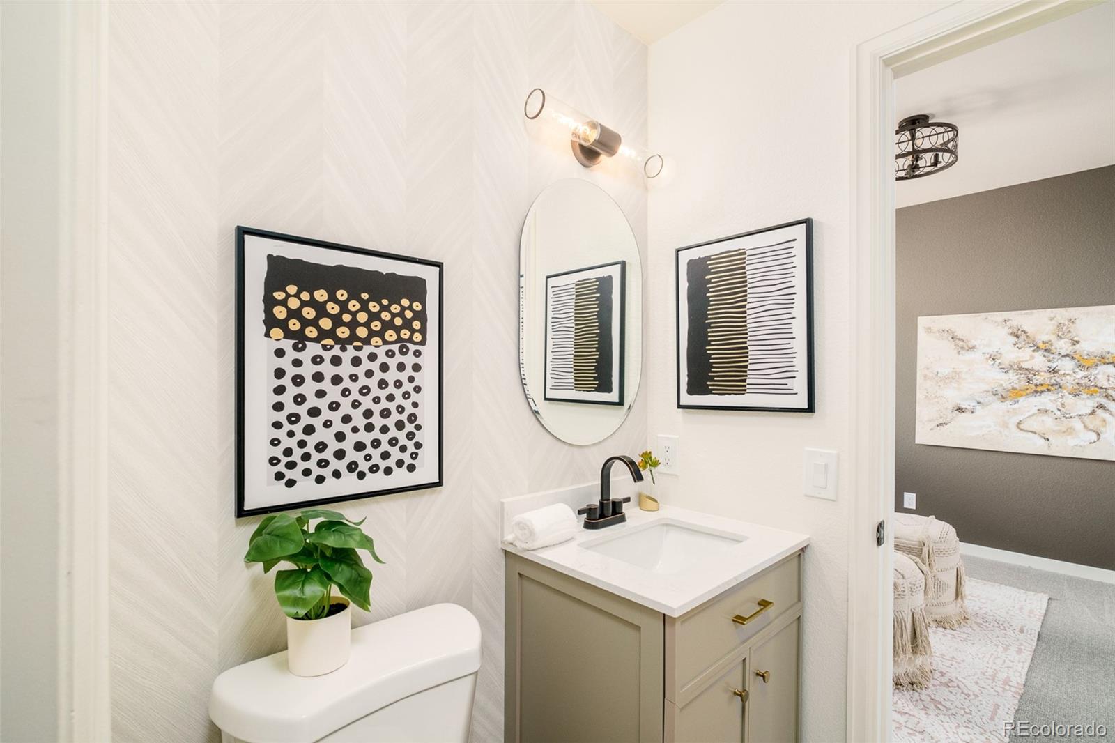8176 Lone Oak Court Lone Tree, CO 80124 - Photo 16 of 50 a bathroom with a toilet sink and mirror