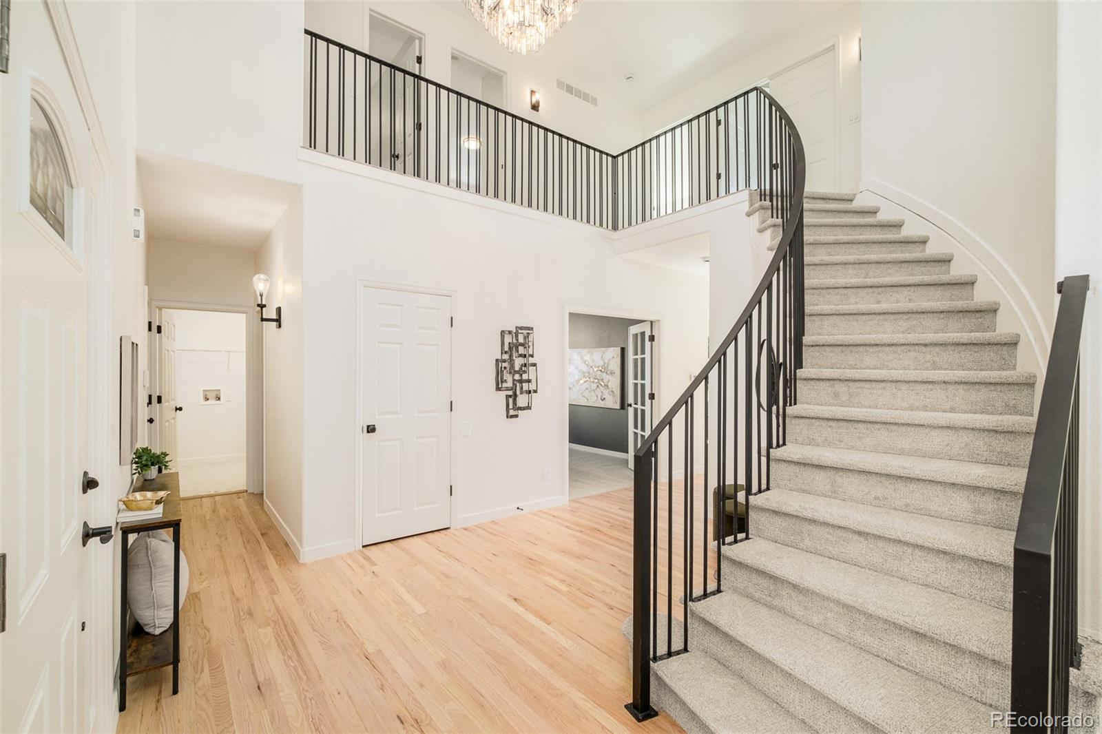 8176 Lone Oak Court Lone Tree, CO 80124 - Photo 18 of 50 a view of entryway and hall with wooden floor