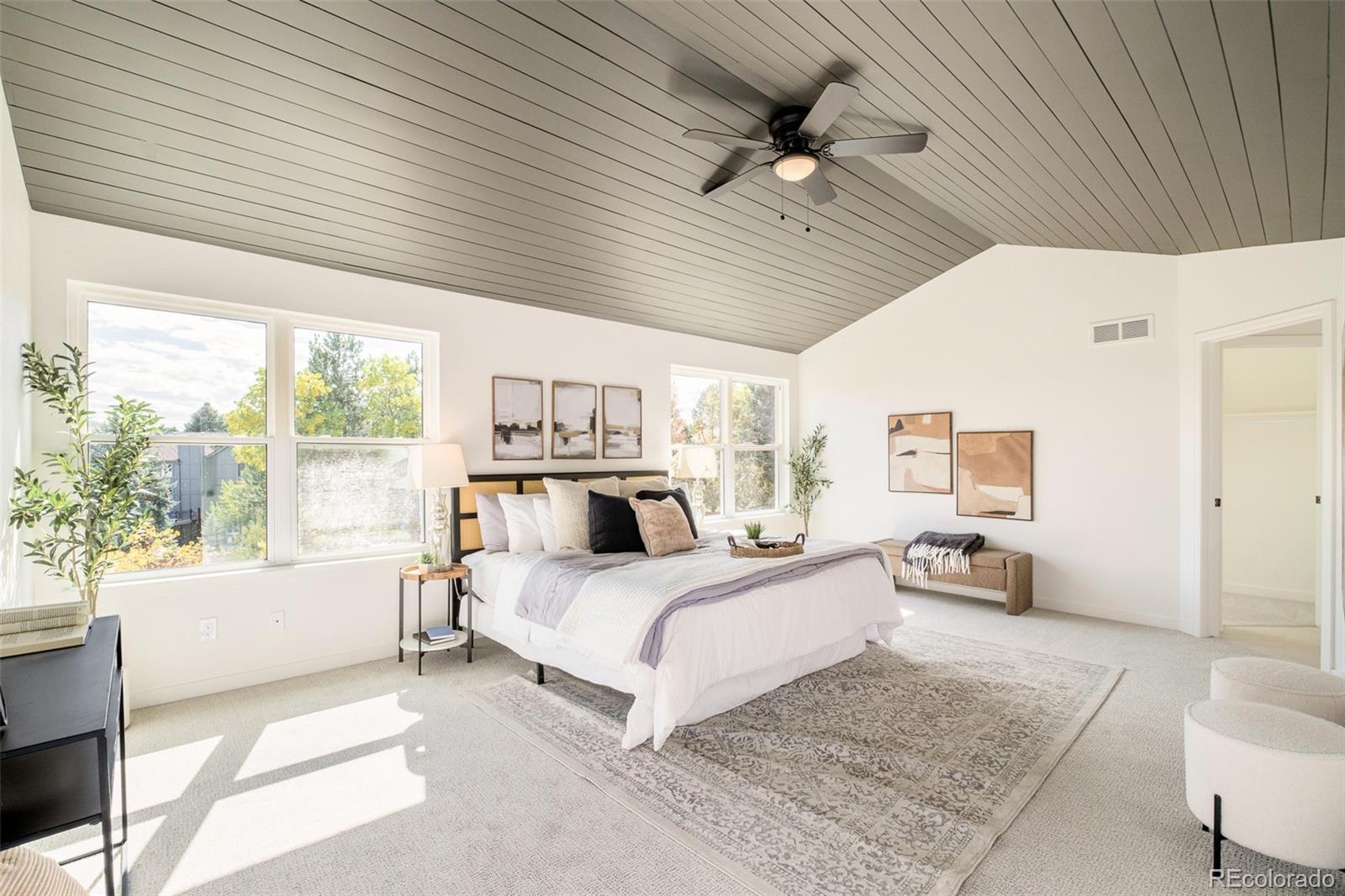 8176 Lone Oak Court Lone Tree, CO 80124 - Photo 20 of 50 a bedroom with a large bed and a couch