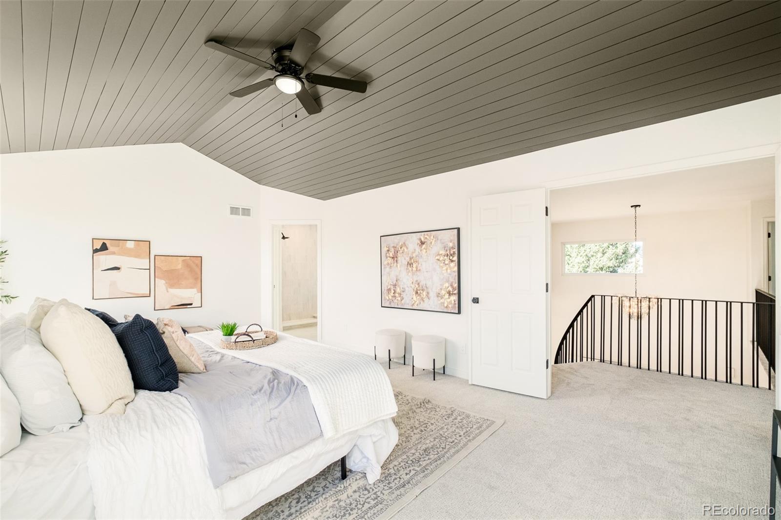 8176 Lone Oak Court Lone Tree, CO 80124 - Photo 22 of 50 a spacious bedroom with a bed and a ceiling fan