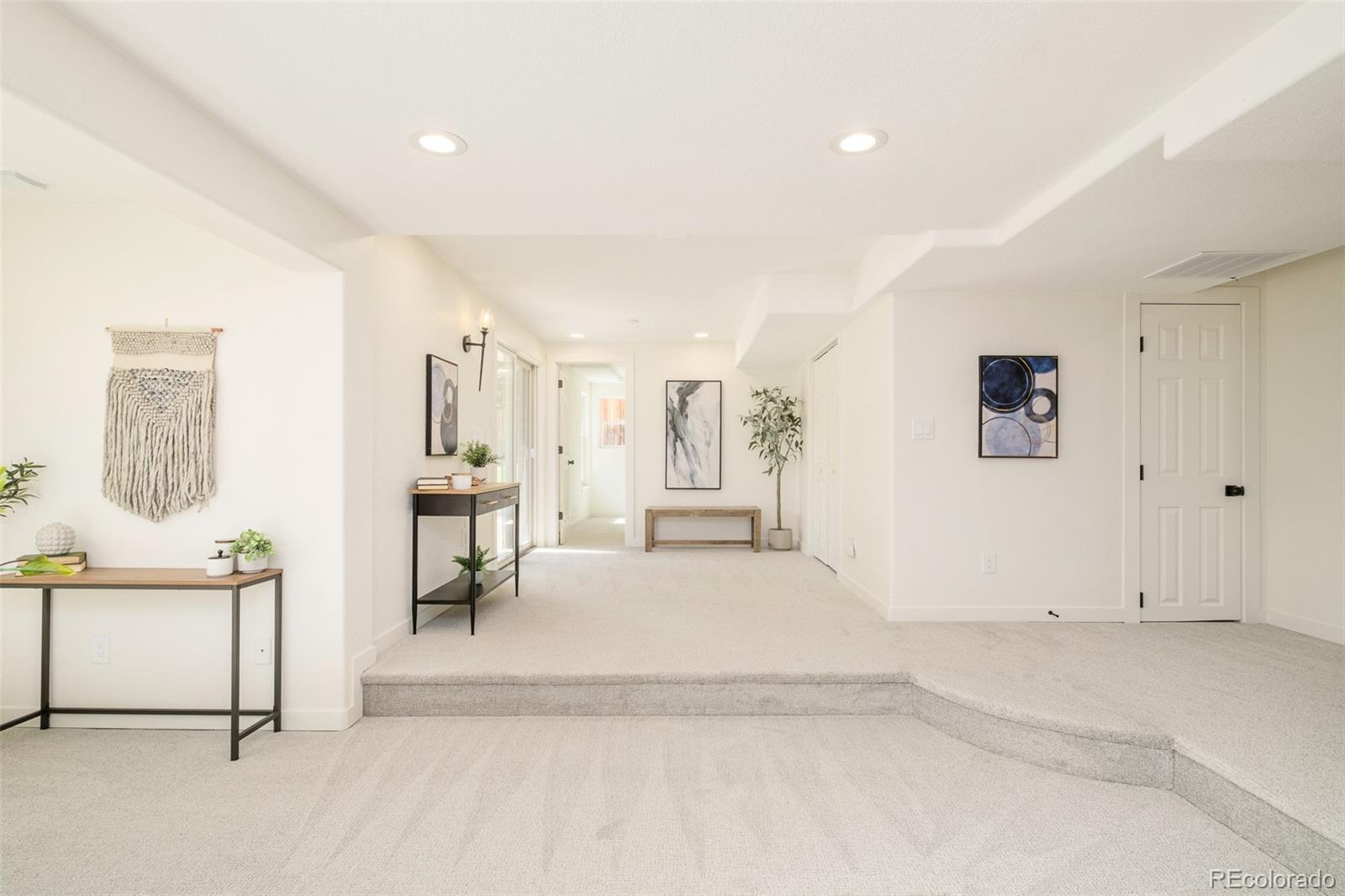 8176 Lone Oak Court Lone Tree, CO 80124 - Photo 32 of 50 a spacious bedroom with a bed a table and painting on the wall