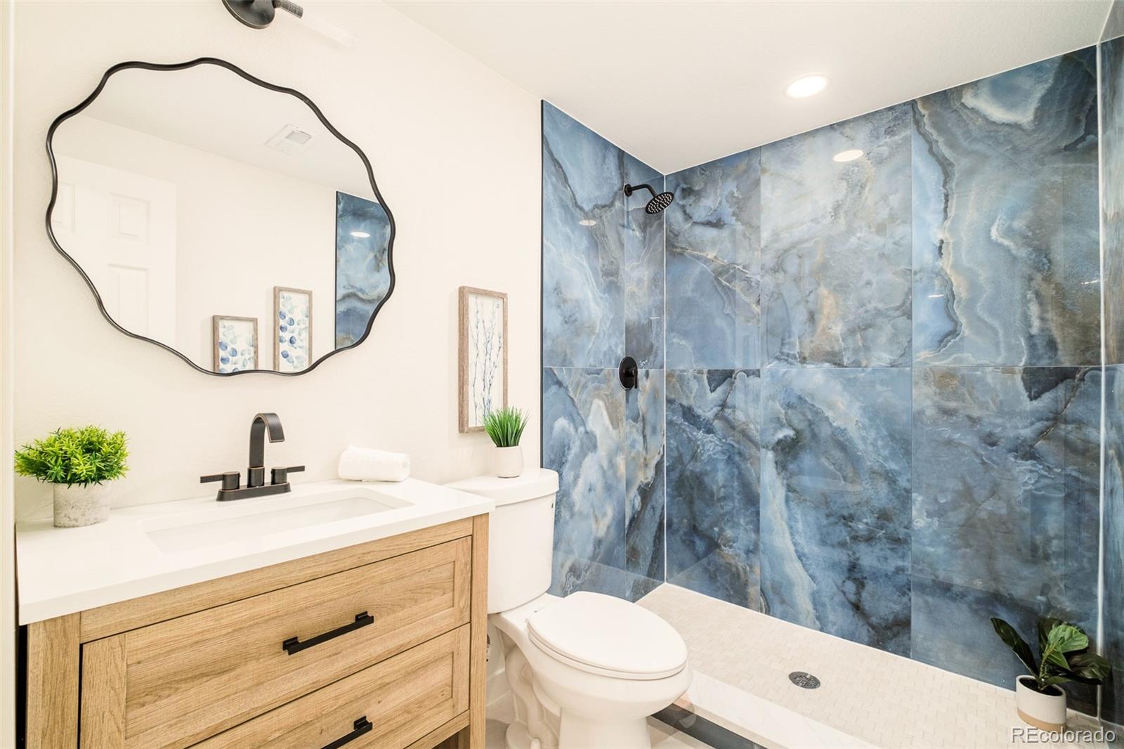 8176 Lone Oak Court Lone Tree, CO 80124 - Photo 36 of 50 a bathroom with a sink vanity mirror and toilet