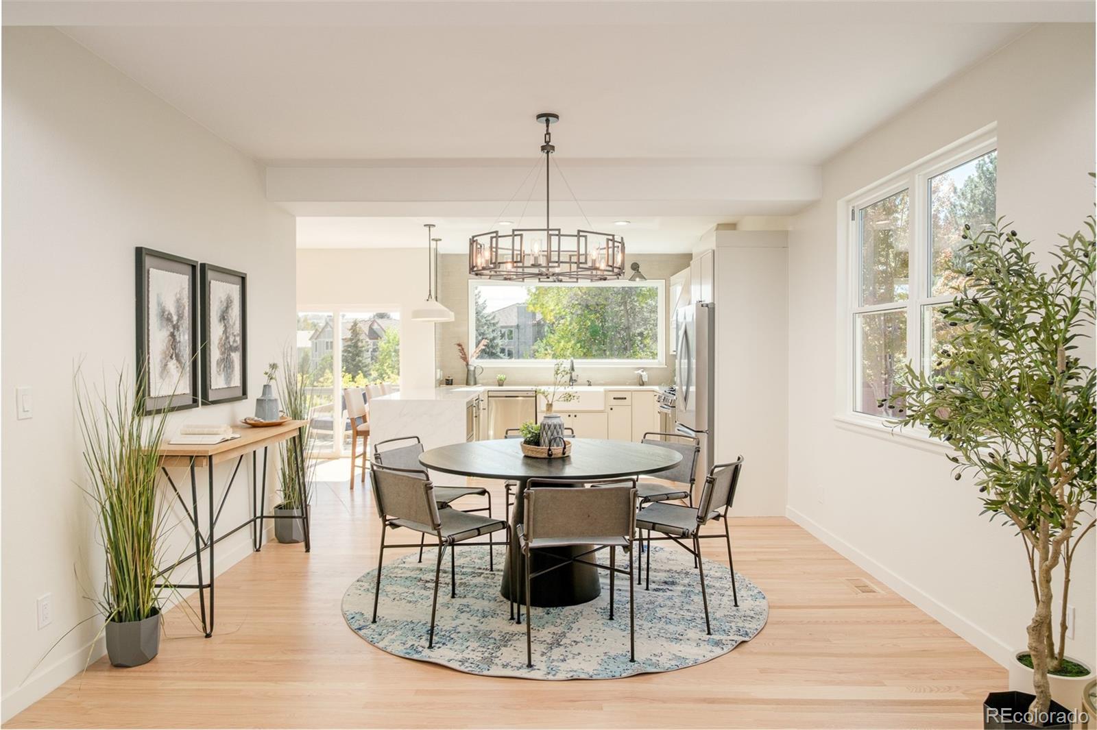 8176 Lone Oak Court Lone Tree, CO 80124 - Photo 7 of 50 a dining room with furniture a chandelier and wooden floor