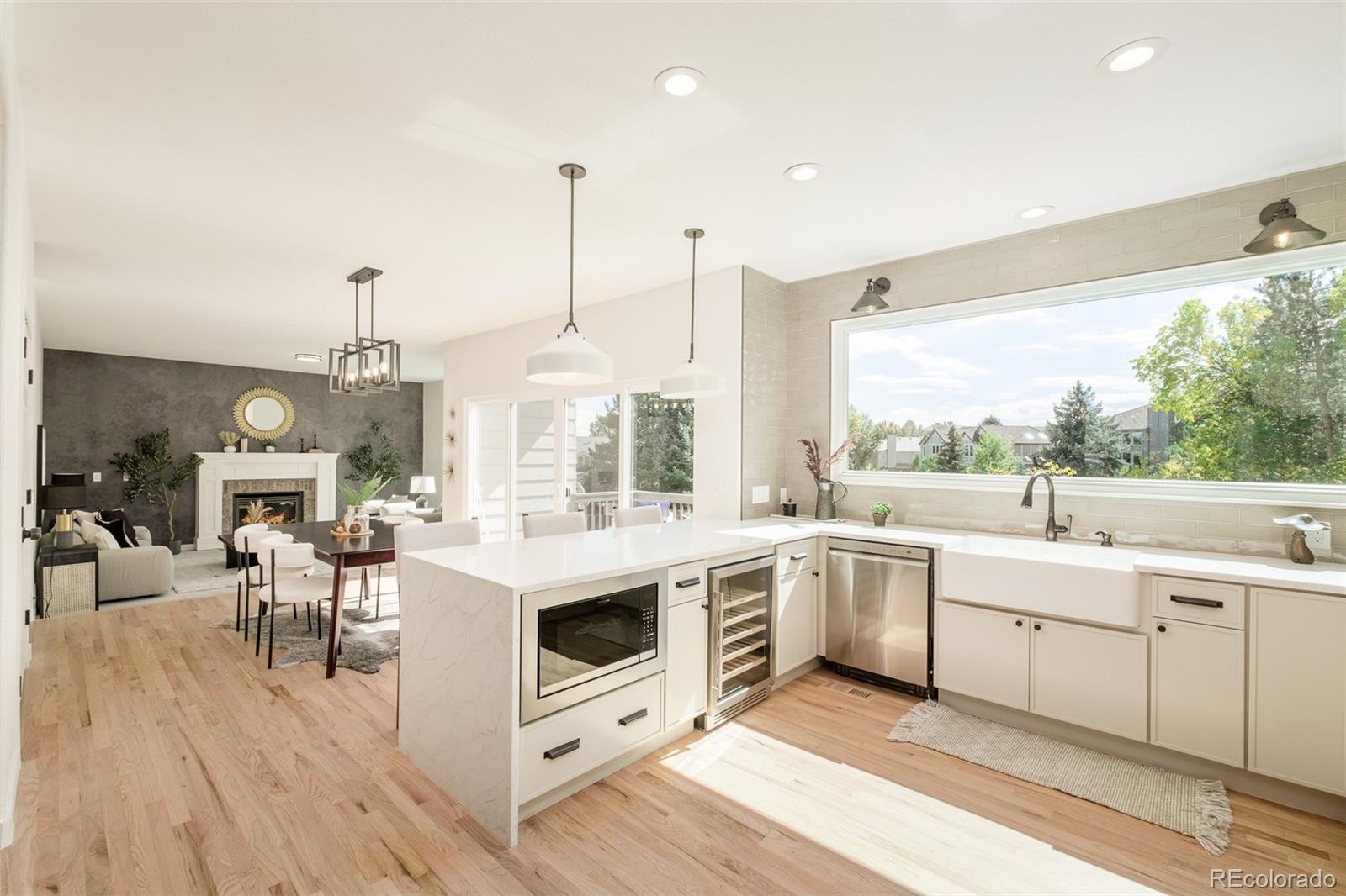 8176 Lone Oak Court Lone Tree, CO 80124 - Photo 8 of 50 a kitchen with a stove a sink and white cabinets with wooden floor