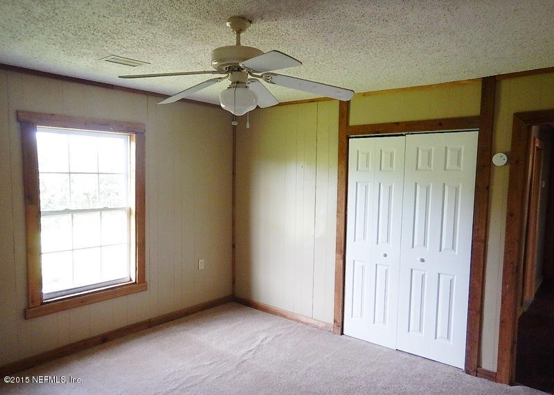 9020 Reid Packing House Road Hastings, FL 32145 - Photo 8 of 10 an empty room with windows and fan