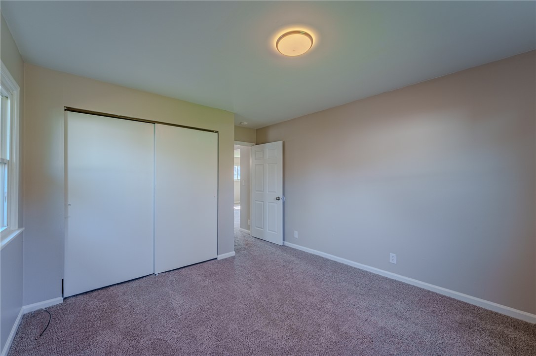 1005 Burt Street Springfield, OH 45505 - Photo 21 of 33 This spacious bedroom offers ample natural light and plush carpeting, creating a comfortable and inviting atmosphere.