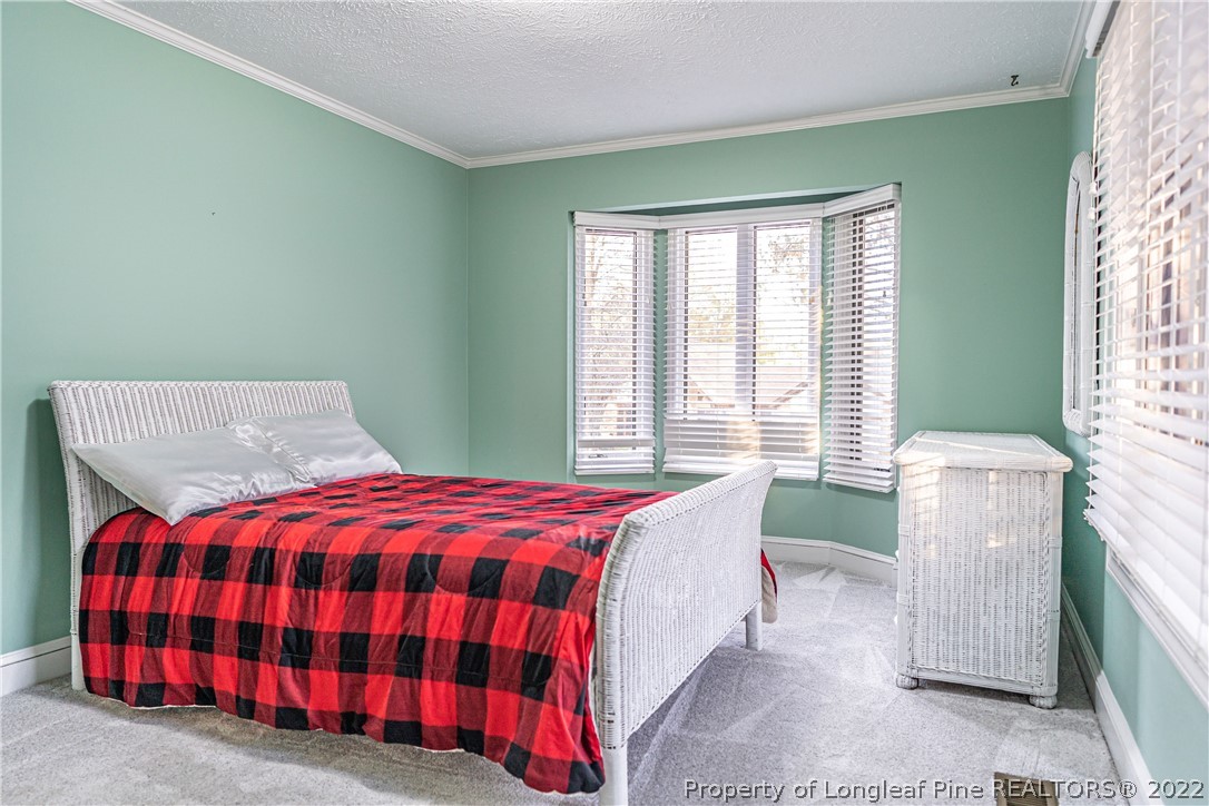 1075 Burning Tree Road Pinehurst, NC 28374 - Photo 17 of 25 a bedroom with a bed and a window