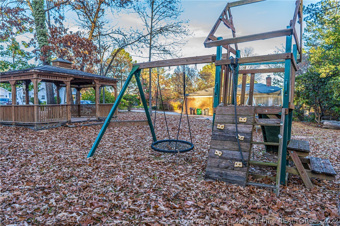 1075 Burning Tree Road Pinehurst, NC 28374 - Photo 20 of 25 a view of a house with backyard from a patio