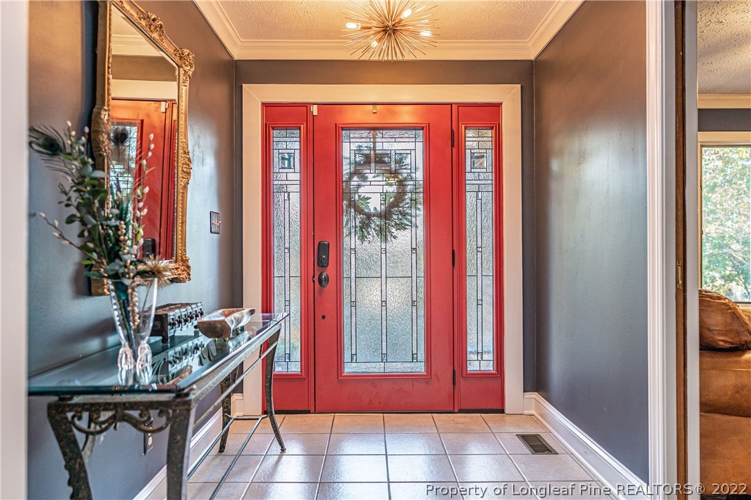 1075 Burning Tree Road Pinehurst, NC 28374 - Photo 3 of 25 a view of a entryway with a potted plant and front door