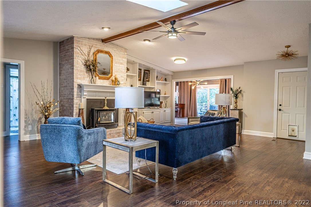 1075 Burning Tree Road Pinehurst, NC 28374 - Photo 6 of 25 a living room with furniture and a fireplace