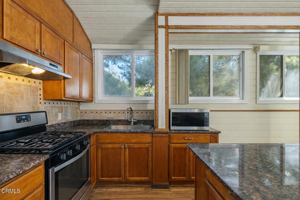 561 East Telegraph Road Fillmore, CA 93015 - Photo 11 of 29 a kitchen with granite countertop a sink and a stove