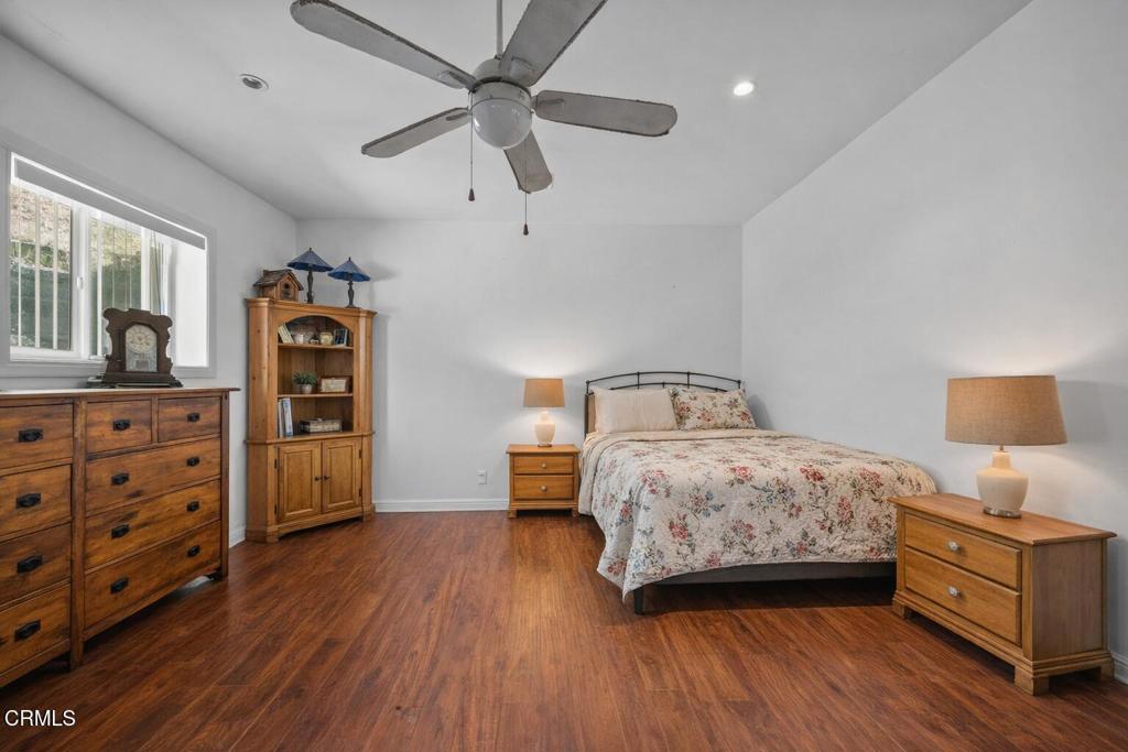 561 East Telegraph Road Fillmore, CA 93015 - Photo 13 of 29 a bedroom with a bed and wooden floor