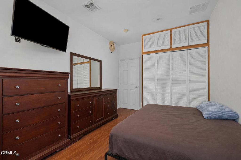 561 East Telegraph Road Fillmore, CA 93015 - Photo 15 of 29 a bedroom with a bed and a flat tv screen on dresser
