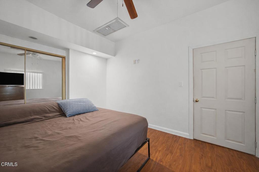 561 East Telegraph Road Fillmore, CA 93015 - Photo 8 of 29 a bedroom with a bed and wooden floor