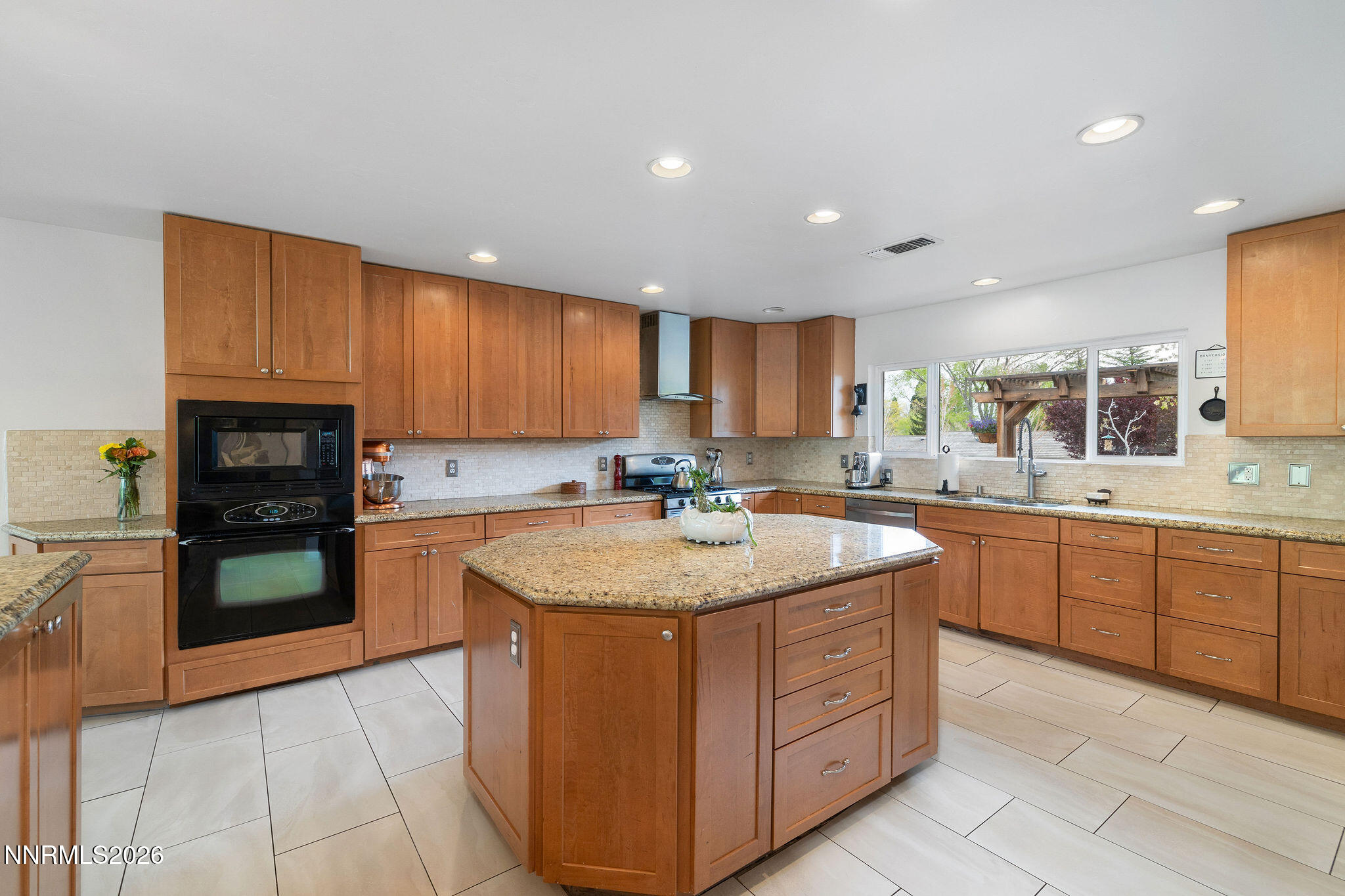 2785 Skyline Boulevard Reno, NV 89509 - Photo 14 of 65 a kitchen with stainless steel appliances granite countertop a sink counter space cabinets and a large window