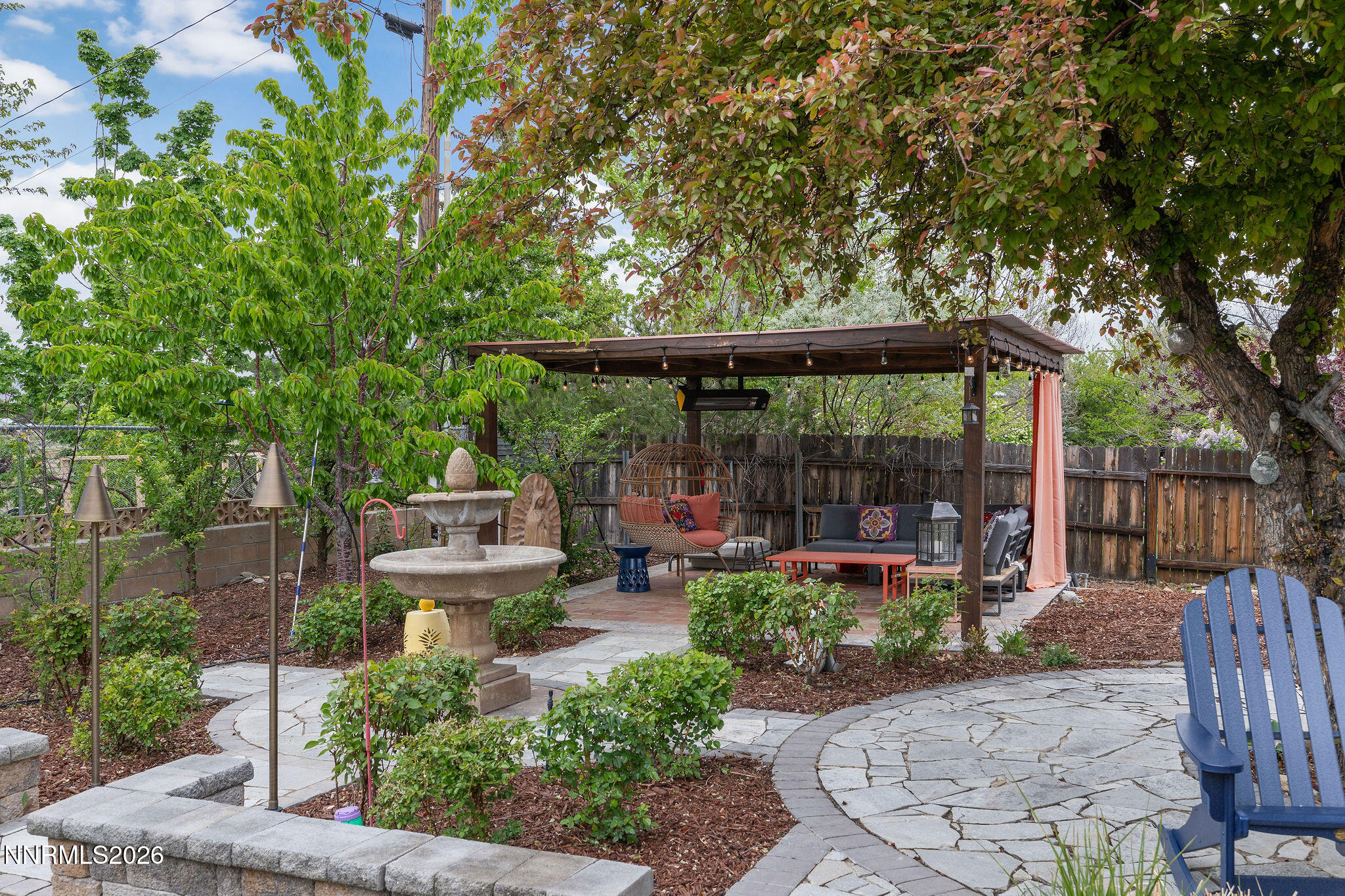 2785 Skyline Boulevard Reno, NV 89509 - Photo 35 of 65 a view of a patio with couches table and chairs potted plants and large tree