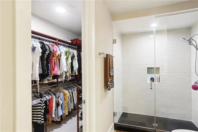a view of walk in closet with clothes