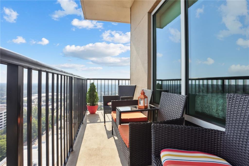 4561 Olde Perimeter Way, Unit 2609 Atlanta, GA 30346 - Photo 20 of 45 a balcony with chairs