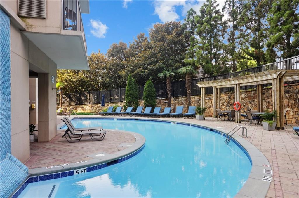 4561 Olde Perimeter Way, Unit 2609 Atlanta, GA 30346 - Photo 2 of 45 a swimming pool with outdoor seating and yard