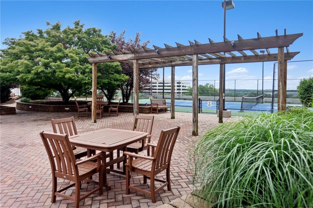 4561 Olde Perimeter Way, Unit 2609 Atlanta, GA 30346 - Photo 23 of 45 a view of a patio with a table and chairs