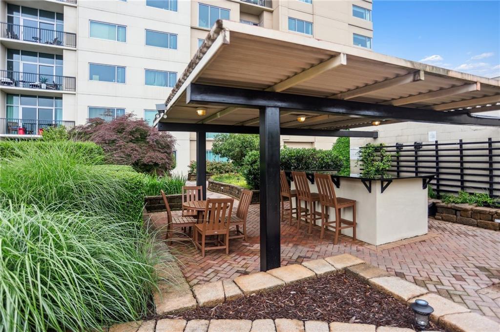 4561 Olde Perimeter Way, Unit 2609 Atlanta, GA 30346 - Photo 24 of 45 a patio with glass top table and chairs