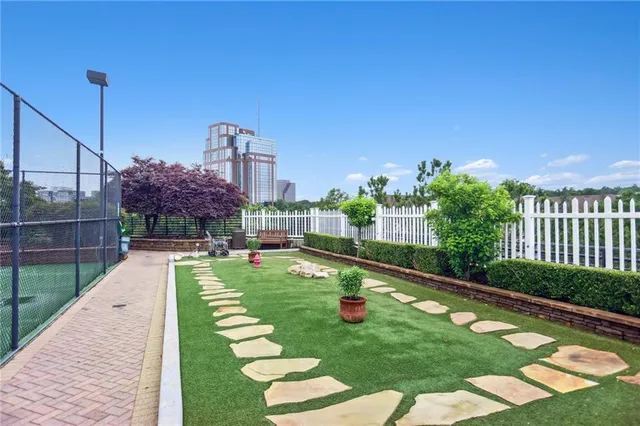 a view of a fountain in the backyard with a small pool