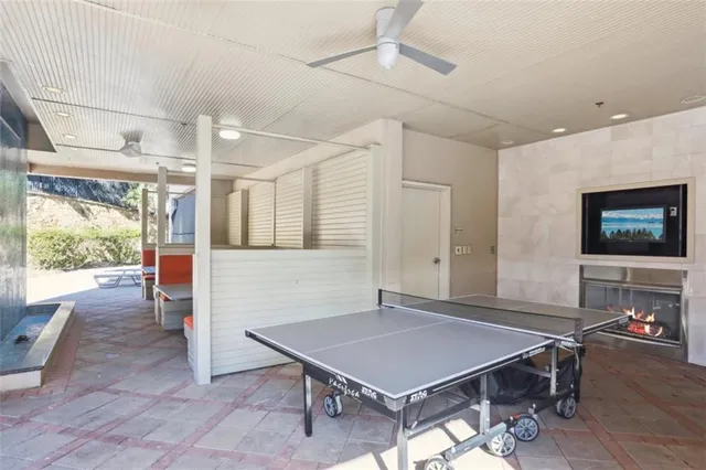 a room with furniture pool table and window